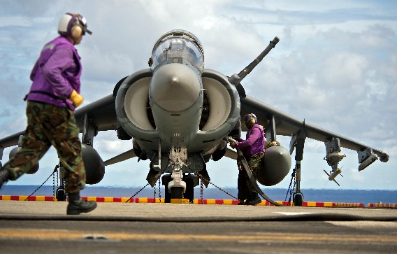 Sailor refuels an AV-8B Harrier.