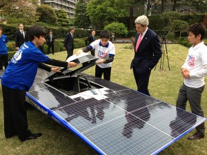 U.S. Secretary of State John Kerry admires a solar-powered car built by members of the TOMODACHI Initiative youth engagement program in Tokyo, Japan