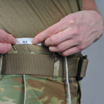 An Airman measures his waist at the 185th Air Refueling Wing // U.S. Air National Guard Photo
